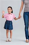 Portrait of a young girl waving