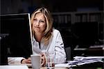 Businesswoman working in dark office