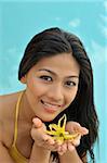 Girl with ylang ylang (Cananga Odorata), an essential  oil widely used in spa and ayurveda and perfumes, Philippines, Southeast Asia, Asia