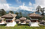 Some of the 108 Chortens located at the summit of the Dochu La Pass with views towards distant forested mountains between Thimpu and Punakha, Bhutan, Himalayas, Asia