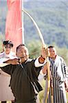 Local man taking part in archery competition using traditional bow, Jakar, Bumthang, Bhutan, Asia
