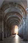 Interior north nave aisle with priest walking away, Vezelay Abbey, UNESCO World Heritage Site, Vezelay, Burgundy, France, Europe