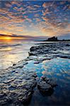 Spectacular sunrise over Bamburgh Castle, Northumberland, England, United Kingdom, Europe