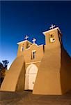 Old Mission of St. Francis de Assisi, built about 1710, illuminated in the late evening, Ranchos de Taos, New Mexico, United States of America, North America