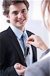 Businessman Receiving Keys from Businesswoman