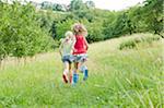 Two Girls Running in Field