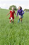 Two Girls Running in Field