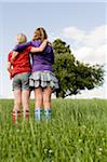 Two Girls Standing in Field