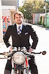 Man Wearing Suit Sitting on Motorcycle