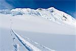 Skier skinning a trail to seracs and icefall at the head of Trimble Glacier below Mount Gerdine, Tordrillo Mountains, Alaska Range, Winter in Southcentral Alaska