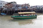 Excursion boat running along the Tai O fishing village, Lantau Island, Hong Kong
