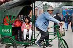 Tricycles running on the street at the front of Kaiyuan temple, old town of Chaozhou, China