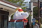 A mascot displayed in front of a shop at Ngon Ping 360, Lantau Island, Hong Kong