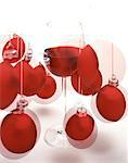 Glass of red wine and red Christmas baubles