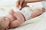 Baby boy having diaper changed