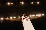 Basketball player standing with arms out, low angle view