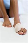 Woman's foot wrapped in brace for injured toe, low section