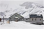 Biscoe House, the main building of the derelict British Antarctic Survey Base at Deception Island which was damaged and abandoned in 1969 after a series of volcanic eruptions from a restless volcano.