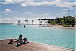 Australia, Queensland, Cairns.  Swimmers relaxing at the Esplanade Lagoon.