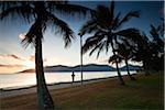 Australia, Queensland, Cairns.  Jogger on the Esplanade at dawn.