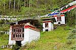 A series of hydro-powered prayer wheels turned by water, en route to Tango Monastery, with little clay tsha tsha images carefully balanced on the window ledges.