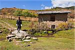 Walking across a clapper bridge in Ura village.