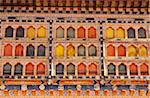 Ornately painted wooden windows at the 17th century Paro Dzong, one of Bhutan's most impressive and well-known dzongs.