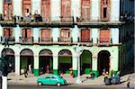 The Caribbean, West Indies, Cuba, Central Havana, classic car parked near old building