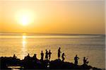 The Caribbean, West Indies, Cuba, Havana, The Malecon, people fishing at sunset