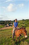 The Caribbean, West Indies, Cuba, Vinales Valley, Unesco World Heritage Site, rancher riding a horse