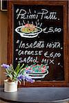 Italy, Tuscany, Lucca. A restaurant menu on display