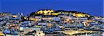 The historical centre and the Sao Jorge castle at dusk. Lisbon, Portugal