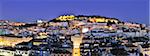 The historical centre and the Sao Jorge castle at dusk. Lisbon, Portugal