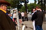 Sakhalin, Yuzhno-Sakhalin, Russia; A street musician playing his saxaphone while a couple spontaneausly dances along