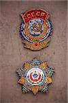 Sakhalin, Yuzhno-Sakhalin, Russia; Badges dating back to the Soviet Union on a wall