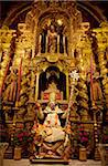 Spain, Andalusia, Seville; Baroque Religious icons in one of the churches in the city centre