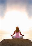 Thailand, Ko Samui, Chaweng beach, Woman meditating on rock