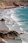 Bodyboarders in the surf at Marloes Sands, Pembrokeshire, Wales.