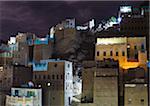 Yemen, Hadhramaut, Wadi Do'an, Khuraibah. Buildings lit at night.