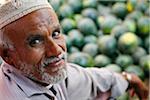 Yemen, Al Hudaydah, Bait Al Faqhi. A man sells watermelons at the Friday market.