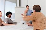 Businessman raising hand in meeting