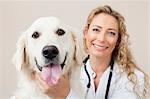 Veterinarian petting dog in office