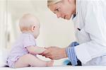 Doctor examining baby in office