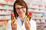 Pharmacist holding bottles of medication