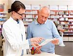 Pharmacist talking to patient in store