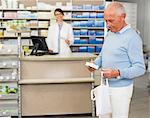 Man picking up prescription at pharmacy