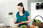 Woman chopping vegetables in kitchen