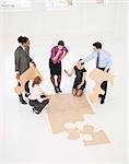 Business people doing puzzle in office