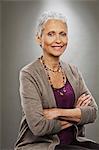 Portrait of senior woman smiling, studio shot