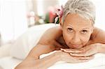 Senior woman relaxing on massage table, portrait